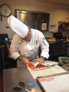 Chef Allen filleting whole salmon